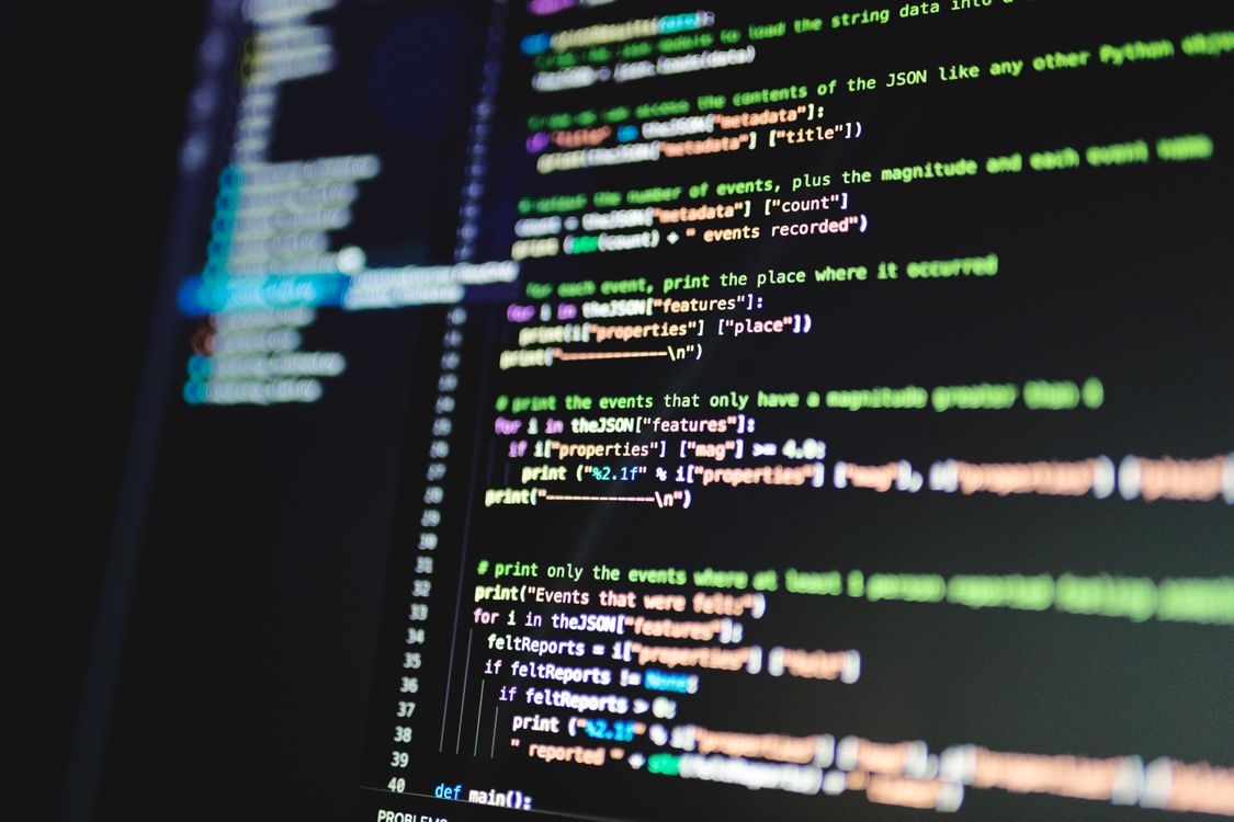 Close-up of colourful programming code on a screen, symbolising the layer behind AI text generation