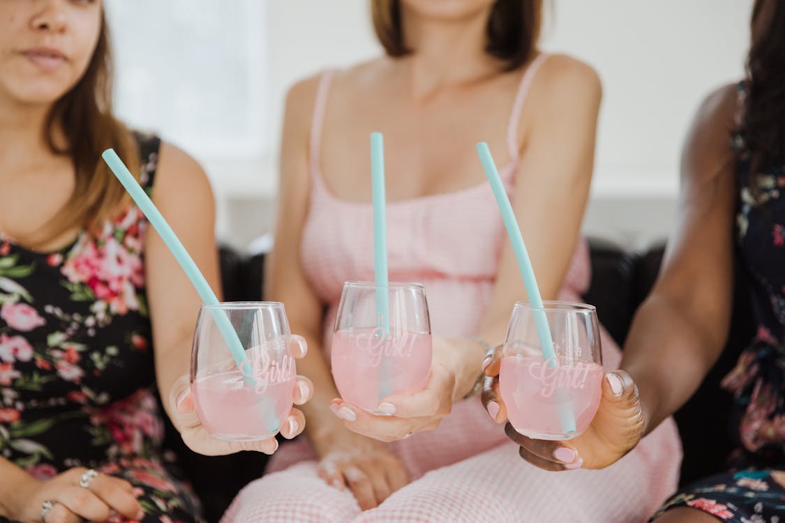 Pregnant woman celebrating at a baby shower with friends