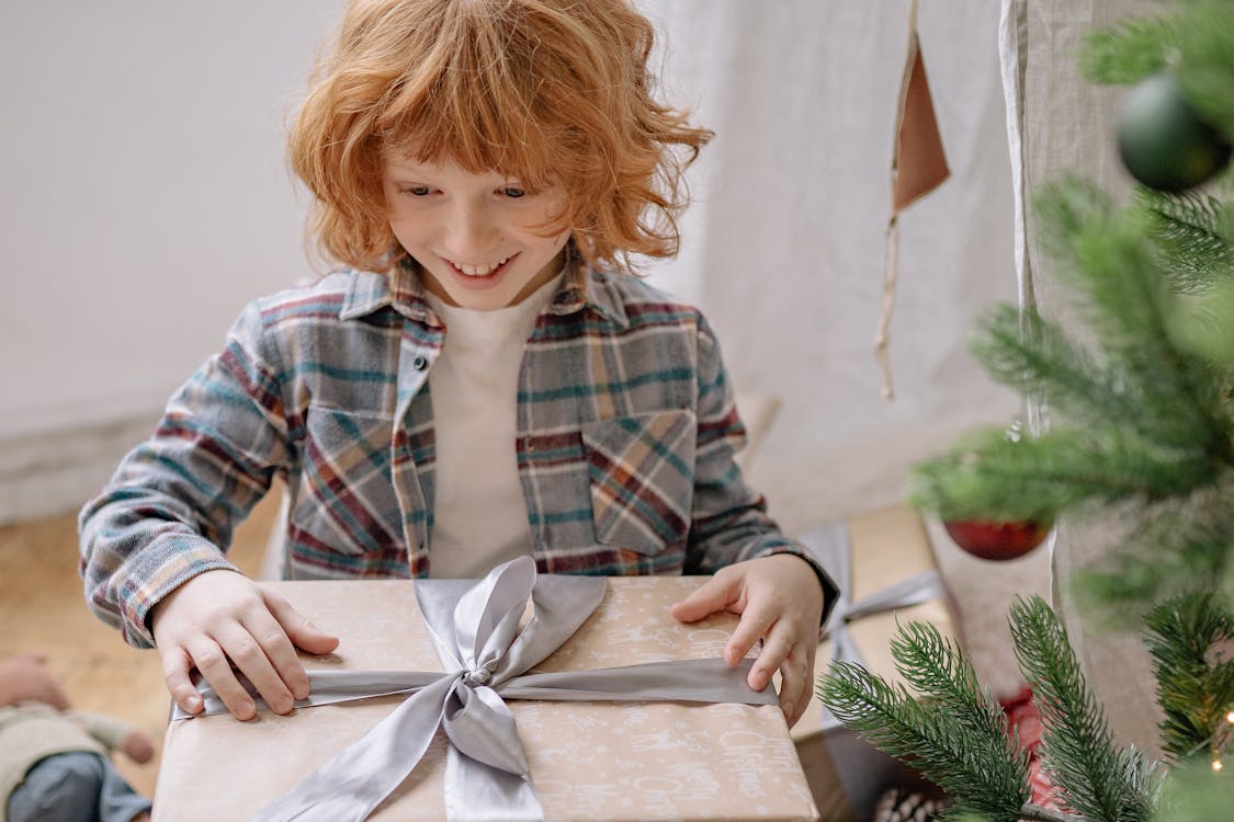 Child surprised and delighted holding a gift