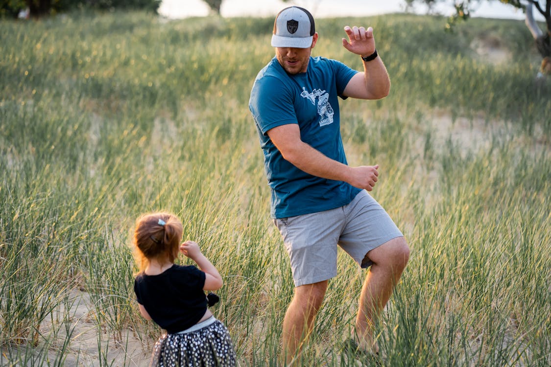 Father and daughter playing together in a field