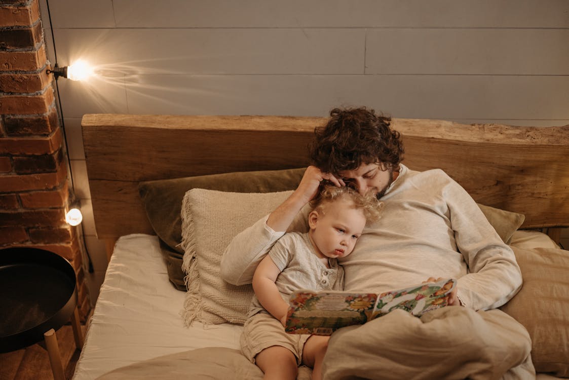 Father reading a bedtime story to his child