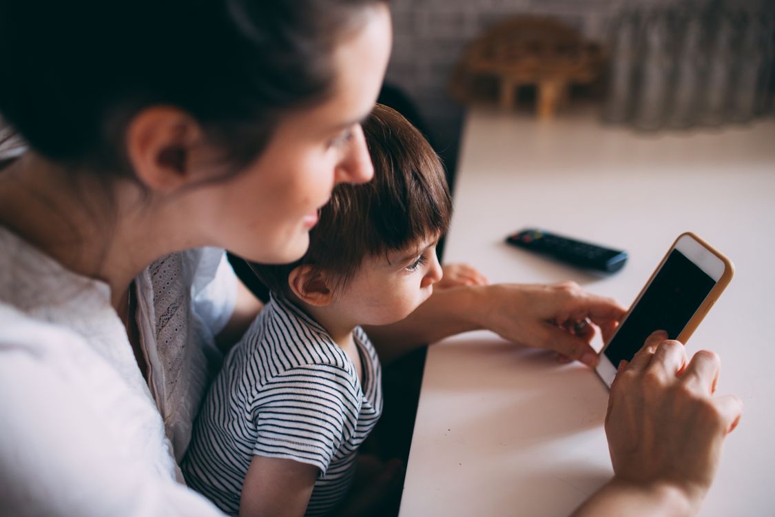 Parent and child looking at a phone together
