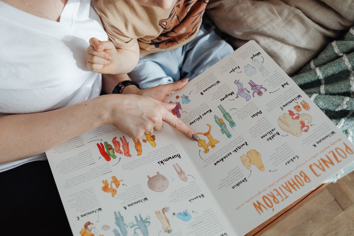 Parent reading a picture book together with a child
