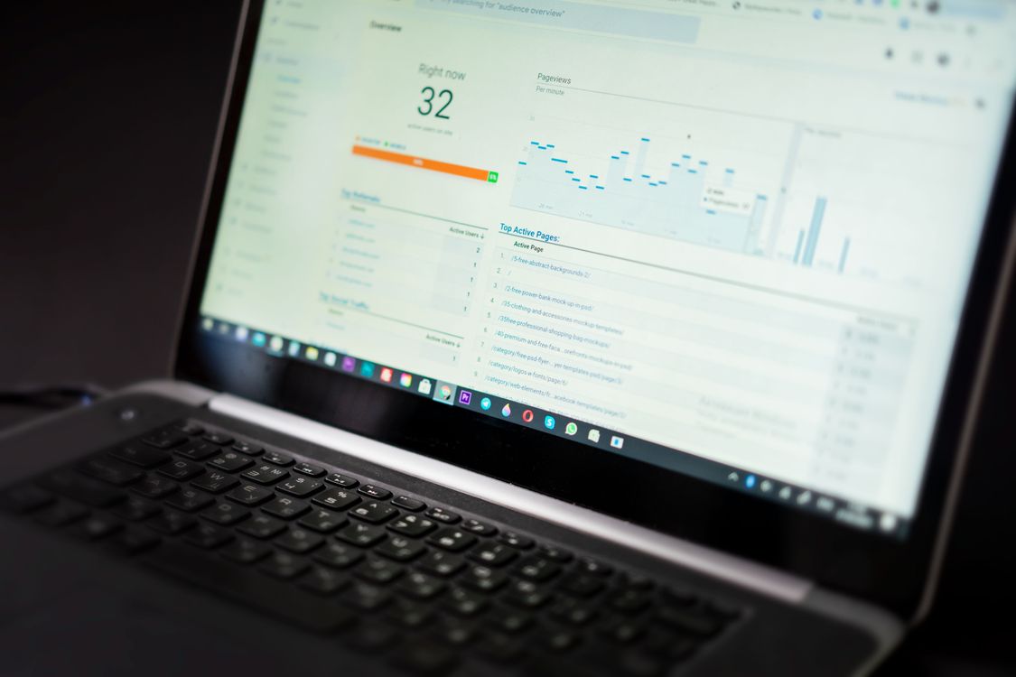 Laptop showing an analytics dashboard full of graphs