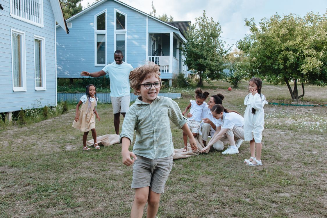 Children and adults playing together outdoors