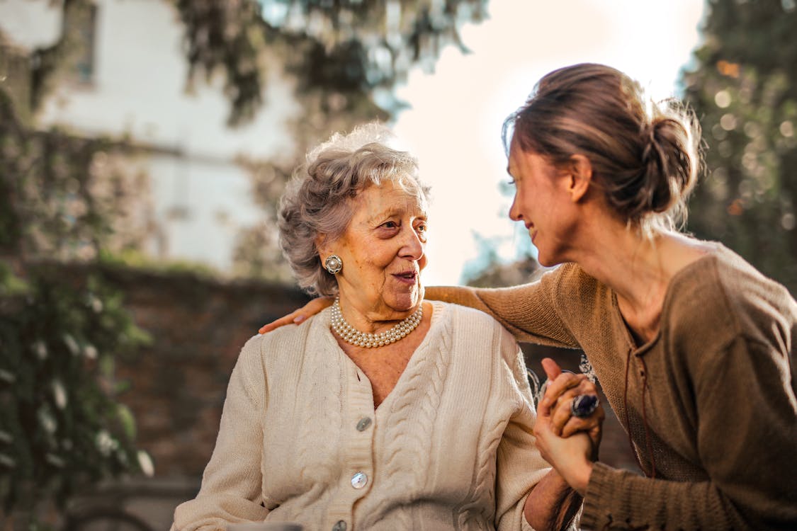 Grandmother embracing her daughter — generations meeting in 50 years together
