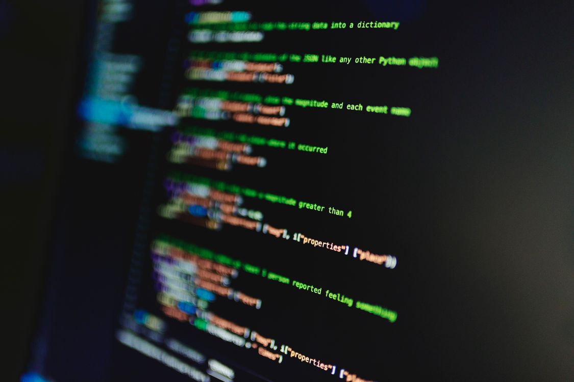 Colourful programming code on a screen, symbolising the layer beneath AI image generation