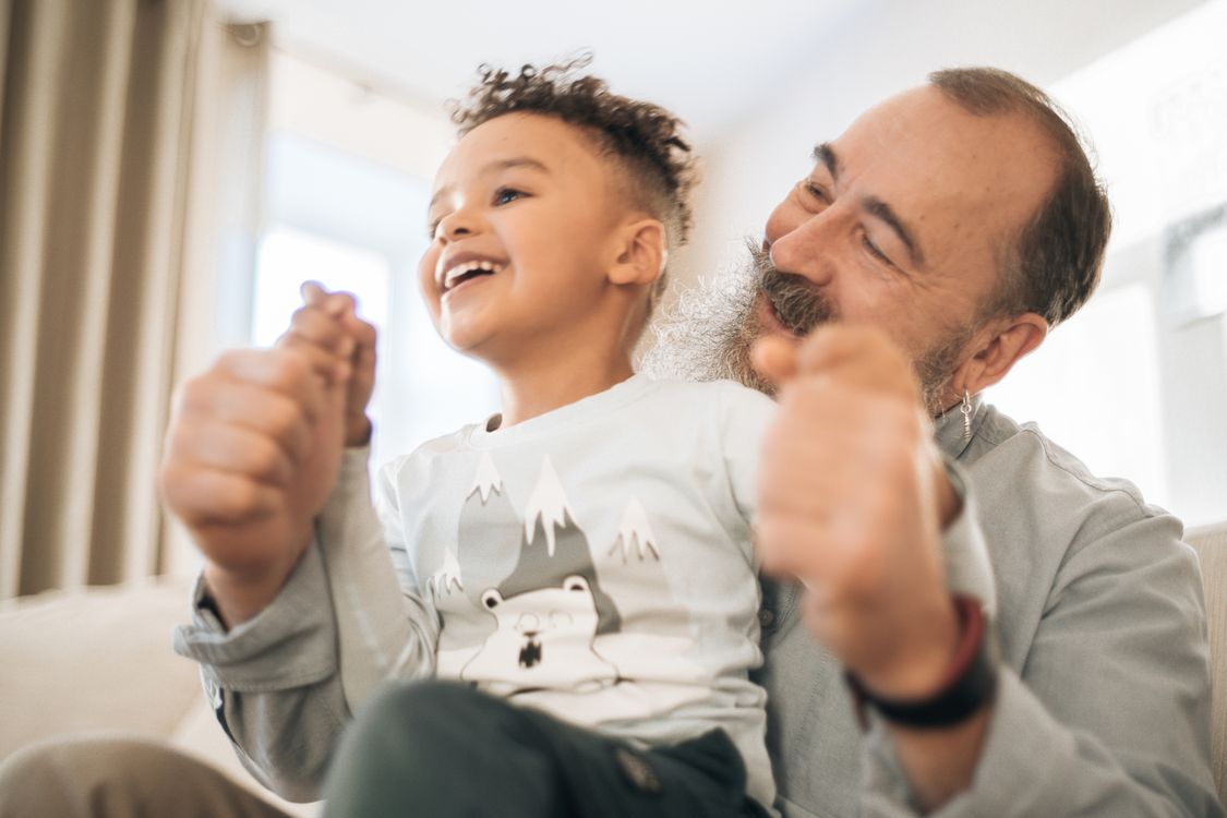 A grandfather and grandson sharing a book together - the result the pipeline is aimed at