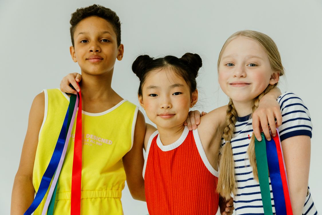Three children holding ribbons, symbolising the choice between different personalised books
