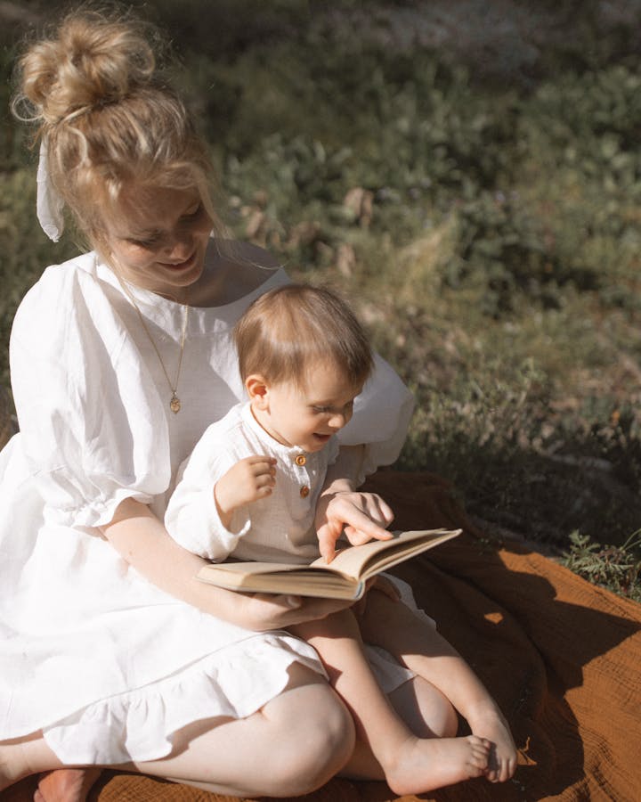 Mum reading with baby on her lap