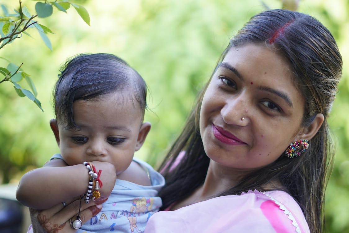 Mother holding baby in traditional cultural attire