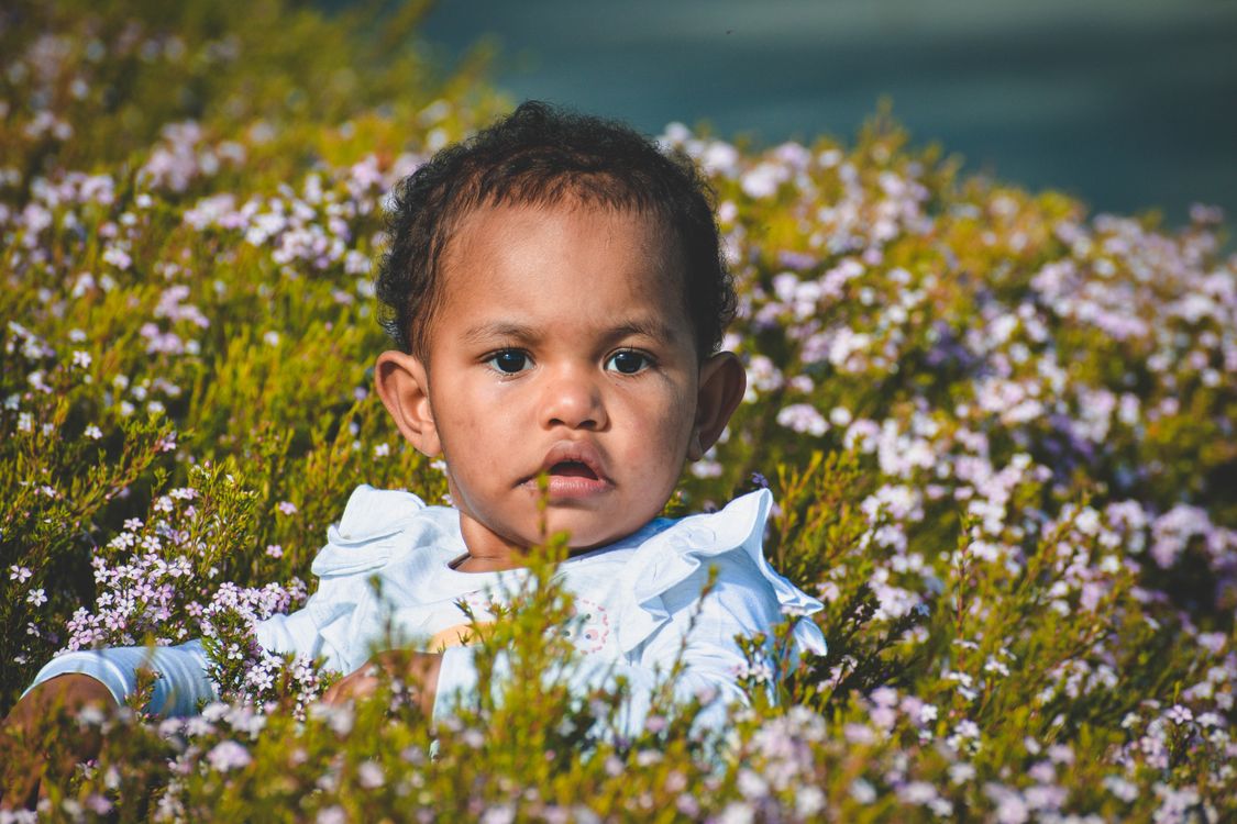 A child among flowers in a fairy-tale setting
