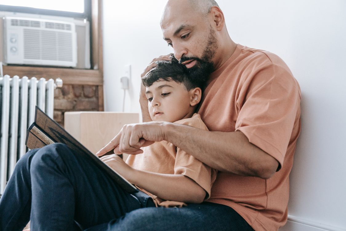 A father reading a personalised children's book to his son