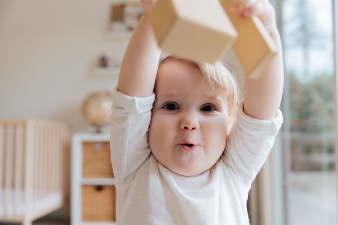 A curious toddler engaged in playful discovery