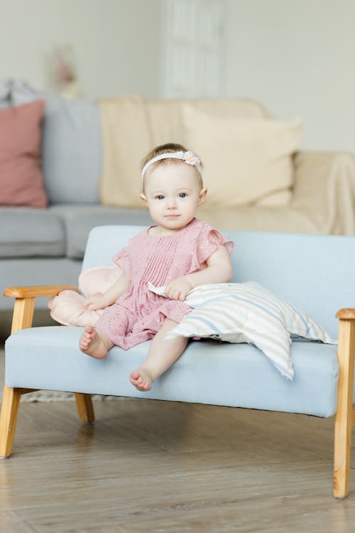 Baby comfortable on a couch — same rules during the day: on the back, no loose items