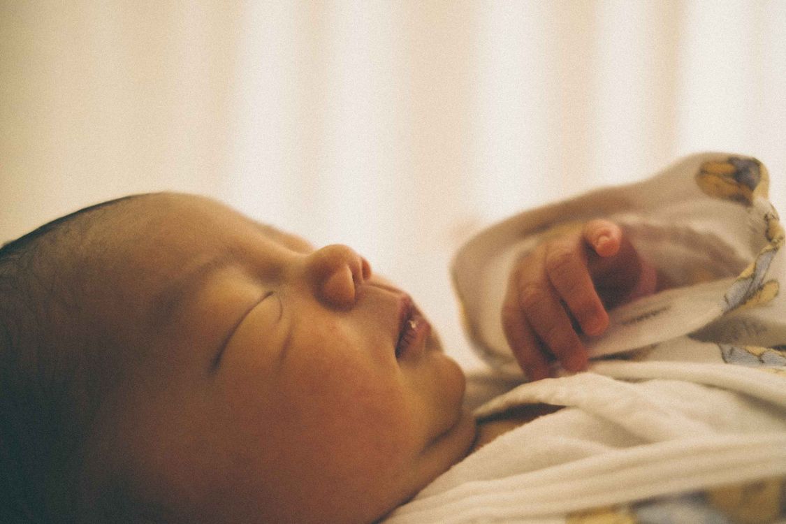 Newborn baby sleeping peacefully in a crib