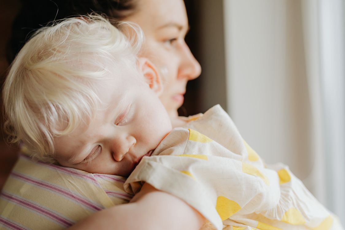 Mother holding her child close in a calm, tender moment