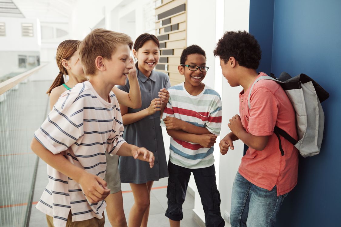 A group of teenagers laughing and talking together